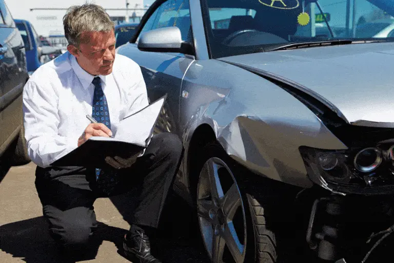 Man assessing car damage