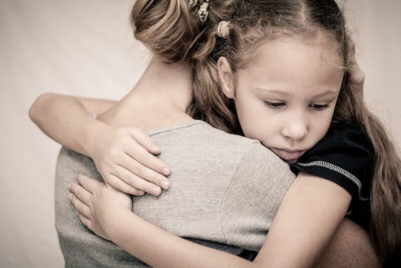 Woman hugging child