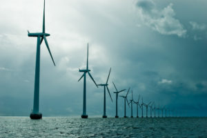 Windmills in a row on cloudy weather