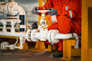 Technician,Hand of technician during open or close manual ball valve for control process in oil and gas flatform offshore