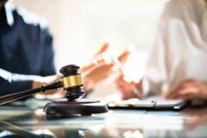 legal discussion between an attorney and a client at a desk with a gavel in the forefront