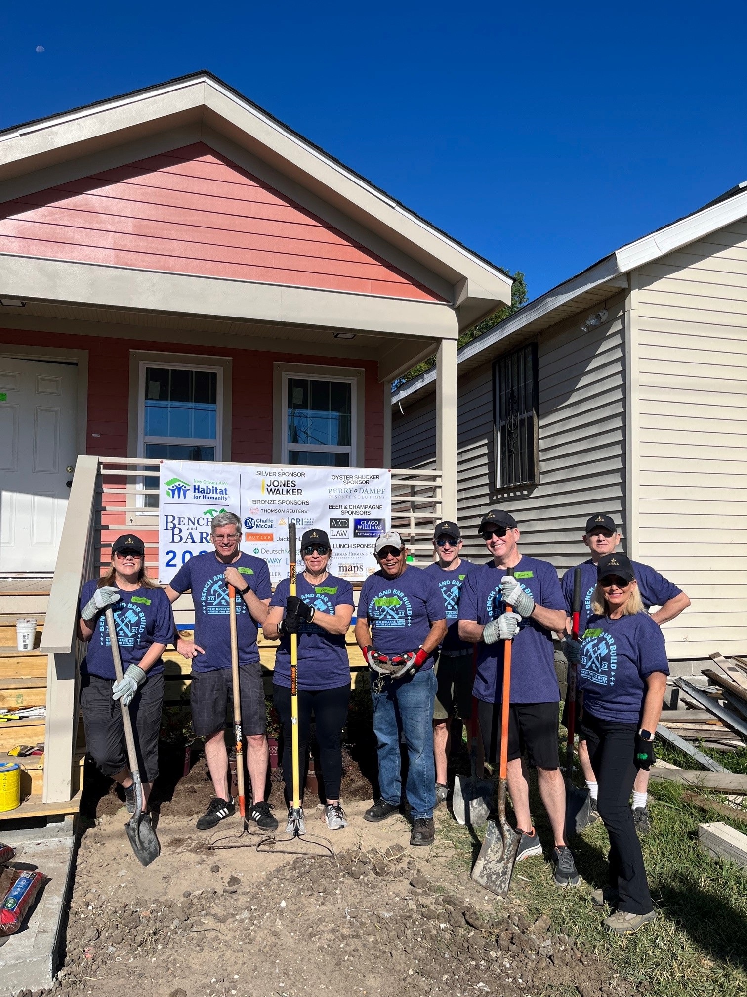 HHK Staff Plus One in Front of Work Site Home