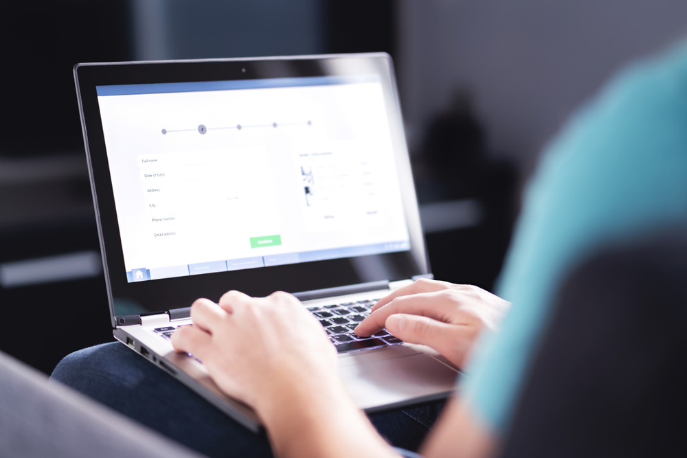 Filling electronic form on internet with laptop