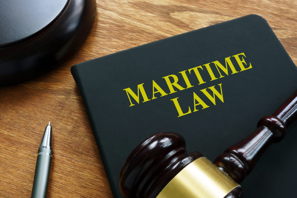 Maritime law black book and wooden gavel.